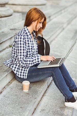 Young student using her laptop to study outside in the street Stock Photo - Budget Royalty-Free & Subscription, Code: 400-07778586