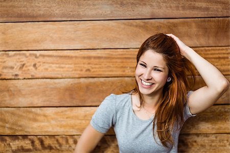 simsearch:400-07778671,k - Happy beautiful redhead touching her hair in the city Fotografie stock - Microstock e Abbonamento, Codice: 400-07778650