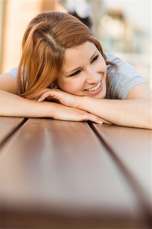 simsearch:400-07778671,k - Smiling casual redhead lying on bench in the city Fotografie stock - Microstock e Abbonamento, Codice: 400-07778661