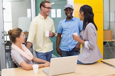 Group of young colleagues with coffee cups during break at office Stock Photo - Budget Royalty-Free & Subscription, Code: 400-07778761