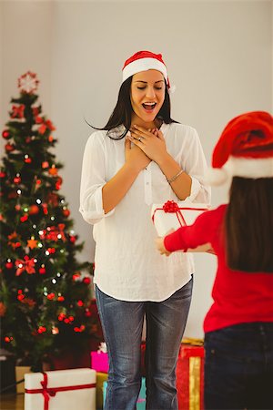 Daughter surprising her mother with christmas gift at home in the living room Stock Photo - Budget Royalty-Free & Subscription, Code: 400-07779139