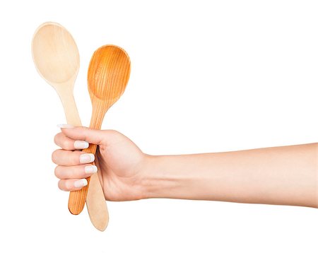 Woman hand with wooden spoon isolated on white background Stock Photo - Budget Royalty-Free & Subscription, Code: 400-07779496