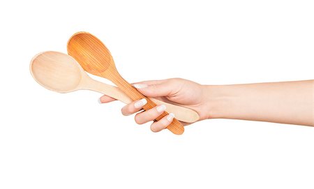Woman hand with wooden spoon isolated on white background Stock Photo - Budget Royalty-Free & Subscription, Code: 400-07779497