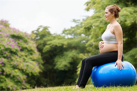 simsearch:693-03308178,k - Portrait of white beautiful pregnant woman doing fitness exercise in park training back muscles on fitness ball. Copy space Stock Photo - Budget Royalty-Free & Subscription, Code: 400-07779700