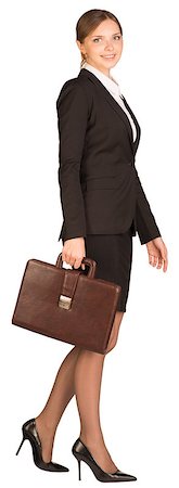 Businesswoman walks holding briefcase in his hand. Isolated on white background Foto de stock - Super Valor sin royalties y Suscripción, Código: 400-07771366