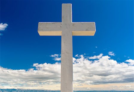 simsearch:400-08975570,k - White cross against blue sky and fluffy clouds Stock Photo - Budget Royalty-Free & Subscription, Code: 400-07771474
