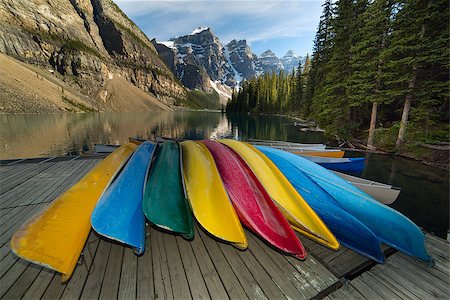 colorful canoes on wooden deck by a lake with mountain cliffs in the background Stock Photo - Budget Royalty-Free & Subscription, Code: 400-07771610