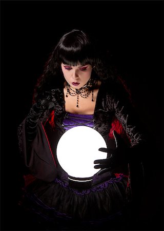 simsearch:400-07776243,k - Attractive witch or fortune teller looking into a crystal ball, Halloween theme Fotografie stock - Microstock e Abbonamento, Codice: 400-07772555