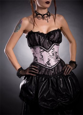 simsearch:400-07549730,k - Elegant woman in corset with floral pattern, studio shot on black background Stock Photo - Budget Royalty-Free & Subscription, Code: 400-07772568