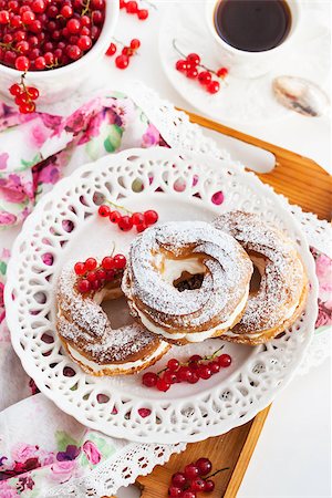 profiterole cake - Cream puff rings (choux pastry) decorated with fresh red currant Stock Photo - Budget Royalty-Free & Subscription, Code: 400-07772603