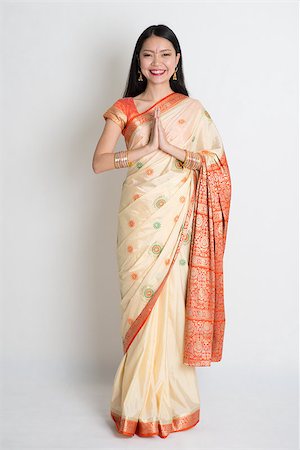 simsearch:400-08223620,k - Asian Indian girl in a greeting pose, traditional sari costume, full length standing on plain background Stock Photo - Budget Royalty-Free & Subscription, Code: 400-07772764