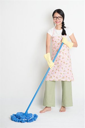 Full length Asian Chinese girl housekeeping, mopping floor on plain background. Stock Photo - Budget Royalty-Free & Subscription, Code: 400-07772763