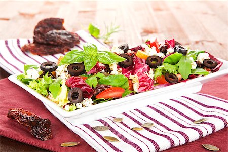 simsearch:400-07485939,k - Delicious vegetable mix salad on white plate with dried tomatoes and seeds. Stock Photo - Budget Royalty-Free & Subscription, Code: 400-07772929