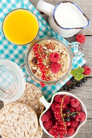 simsearch:400-05735704,k - Healthy breakfast with muesli, berries, orange juice and milk. On wooden table Photographie de stock - Aubaine LD & Abonnement, Code: 400-07773148