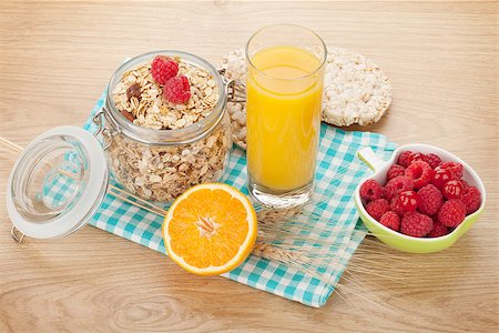 porridge and berries - Healthy breakfast with muesli, berries and orange juice. On wooden table Stock Photo - Budget Royalty-Free & Subscription, Code: 400-07773141
