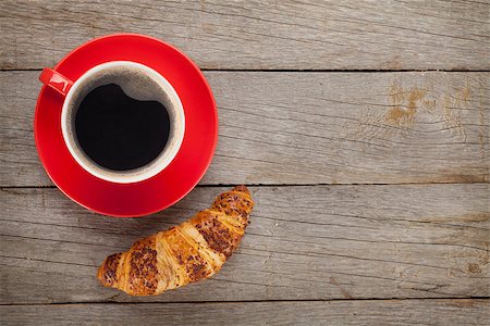 simsearch:400-06142439,k - Cup of coffee and fresh croissant on wooden table with copy space Stock Photo - Budget Royalty-Free & Subscription, Code: 400-07773142