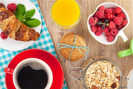 simsearch:400-08113690,k - Healthy breakfast with muesli, berries, orange juice, coffee and croissant. View from above on wooden table Stock Photo - Budget Royalty-Free & Subscription, Code: 400-07773159
