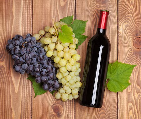 simsearch:400-08110621,k - Red wine bottle and bunch of grapes on wooden table background Stock Photo - Budget Royalty-Free & Subscription, Code: 400-07773234