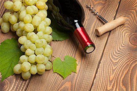 simsearch:400-08110621,k - Red wine bottle and bunch of white grapes on wooden table background Stock Photo - Budget Royalty-Free & Subscription, Code: 400-07773239