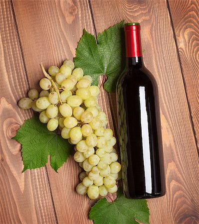 simsearch:400-08110621,k - Red wine bottle and bunch of white grapes on wooden table background Stock Photo - Budget Royalty-Free & Subscription, Code: 400-07773232