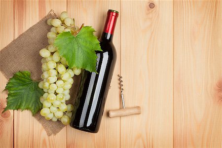 simsearch:400-08110621,k - Red wine bottle and bunch of white grapes on wooden table background with copy space Stock Photo - Budget Royalty-Free & Subscription, Code: 400-07773245