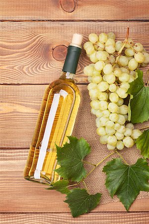 simsearch:400-08110621,k - White wine bottle and bunch of white grapes on wooden table background Stock Photo - Budget Royalty-Free & Subscription, Code: 400-07773242