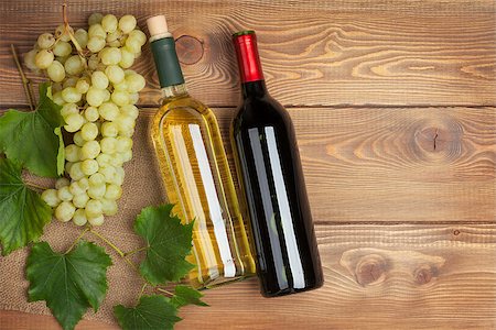 simsearch:400-08110621,k - Red and white wine bottles and bunch of grapes on wooden table background with copy space Stock Photo - Budget Royalty-Free & Subscription, Code: 400-07773243