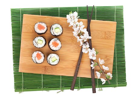 simsearch:400-08072780,k - Sushi maki set with salmon and cucumber and sakura branch. Isolated on white background Photographie de stock - Aubaine LD & Abonnement, Code: 400-07773306