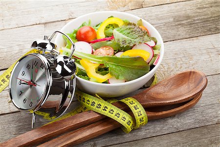 simsearch:400-06485512,k - Fresh healthy salad and measuring tape on wooden table. Healthy food Stock Photo - Budget Royalty-Free & Subscription, Code: 400-07773334