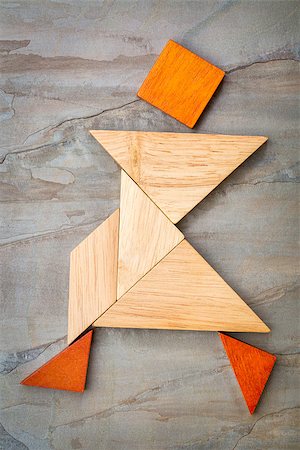 simsearch:400-07774007,k - abstract of a dancing or walking figure built from seven tangram wooden pieces, a traditional Chinese puzzle game; slate rock background background, the artwork copyright by the photographer Foto de stock - Royalty-Free Super Valor e Assinatura, Número: 400-07773892