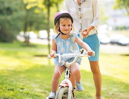 Mother and baby girl riding bicycle outdoors Stock Photo - Budget Royalty-Free & Subscription, Code: 400-07794034