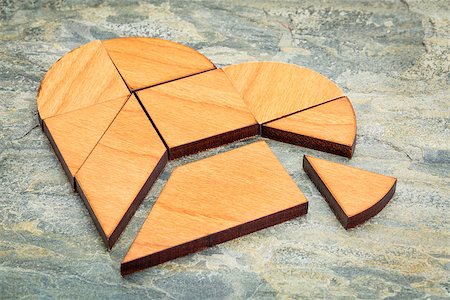 simsearch:400-07774007,k - heart version of tangram, a traditional Chinese Puzzle Game made of different wood parts to build abstract figures from them, on  a slate rock background Foto de stock - Royalty-Free Super Valor e Assinatura, Número: 400-07794450