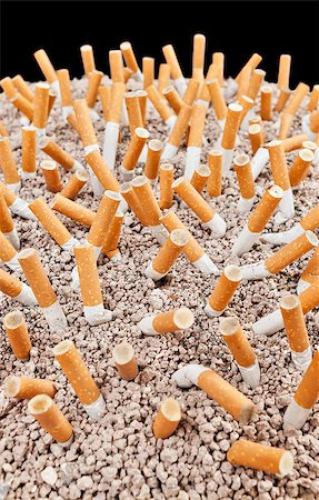 simsearch:400-06876304,k - Ashtray full of smoked cigarettes in the sand Stock Photo - Budget Royalty-Free & Subscription, Code: 400-07794465