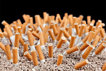 simsearch:400-06876304,k - Ashtray full of smoked cigarettes in the sand Stock Photo - Budget Royalty-Free & Subscription, Code: 400-07794461