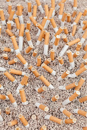 simsearch:400-06876304,k - Ashtray full of smoked cigarettes in the sand from above Stock Photo - Budget Royalty-Free & Subscription, Code: 400-07794463