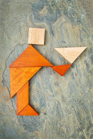 simsearch:400-07774007,k - abstract of a butler, waiter or servant figure built from seven tangram wooden pieces, a traditional Chinese puzzle game; slate rock background, the artwork copyright by the photographer Foto de stock - Royalty-Free Super Valor e Assinatura, Número: 400-07795235