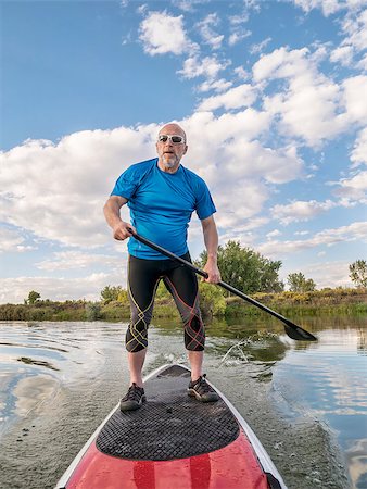 simsearch:400-07795226,k - senior male paddler paddling a stand up paddleboard (SUP), calm lake in Colorado, late summer Foto de stock - Royalty-Free Super Valor e Assinatura, Número: 400-07795428