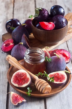 simsearch:400-07219392,k - Ripe purple figs, plums, thyme and homey on olive board. Selective focus. Stock Photo - Budget Royalty-Free & Subscription, Code: 400-07795838