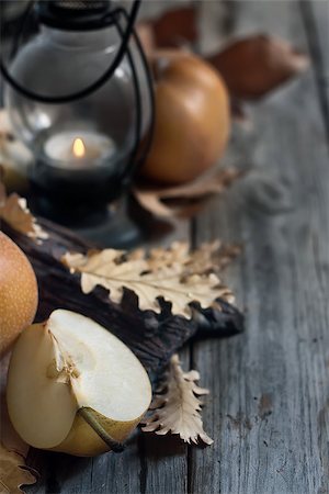 simsearch:400-05381568,k - Ripe asian pears, lantern with candle and fall leaves on wooden table. Autumn concept. Selective focus. Copyspace background. Stock Photo - Budget Royalty-Free & Subscription, Code: 400-07795853