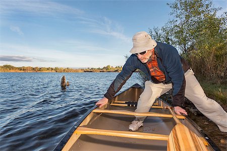 simsearch:400-07795226,k - senior male launching canoe for  morning paddling, on a lake Riverbend Ponds Natural Area, Fort Collins, Colorado Foto de stock - Royalty-Free Super Valor e Assinatura, Número: 400-07796014