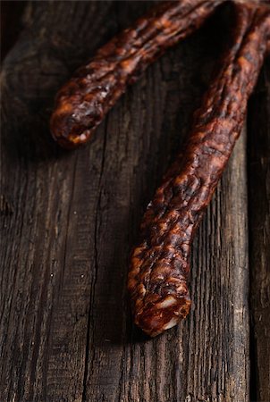 Sausage. Dried Smoked Sausages Sliced on wooden Board. Chorizo sausage Stock Photo - Budget Royalty-Free & Subscription, Code: 400-07796037