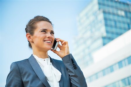 simsearch:400-06642775,k - Smiling business woman talking mobile phone in front of office building Photographie de stock - Aubaine LD & Abonnement, Code: 400-07796648