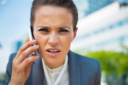 simsearch:400-06642775,k - Portrait of business woman talking cell phone in office district Photographie de stock - Aubaine LD & Abonnement, Code: 400-07796640