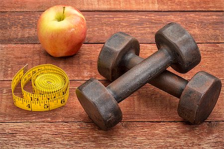 dumbbells, apple and tape measure against weathered barn wood - a fitness concept Stock Photo - Budget Royalty-Free & Subscription, Code: 400-07796814