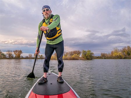 simsearch:400-07795226,k - senior paddler in life jacket enjoying stand up paddling on lake, fall scenery in Fort Collins, Colorado Foto de stock - Royalty-Free Super Valor e Assinatura, Número: 400-07796878