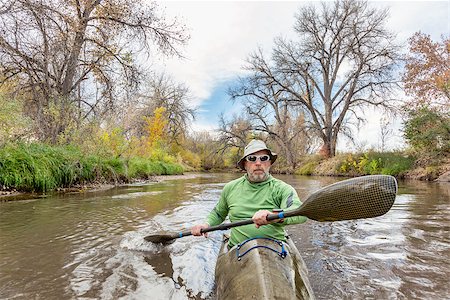 simsearch:400-07795226,k - senior male paddler training in a fast sea kayak used in adventure racing, fall scenery, Poudre RIver in Fort Collins, Colorado, bow view Foto de stock - Royalty-Free Super Valor e Assinatura, Número: 400-07796979