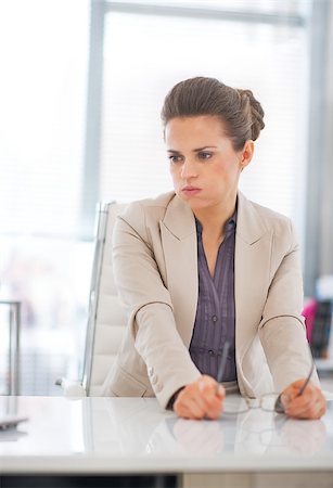 simsearch:400-06139245,k - Portrait of concerned business woman with eyeglasses in office Foto de stock - Royalty-Free Super Valor e Assinatura, Número: 400-07797087