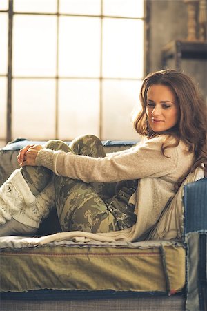 Thoughtful young woman sitting in loft apartment Stock Photo - Budget Royalty-Free & Subscription, Code: 400-07797231