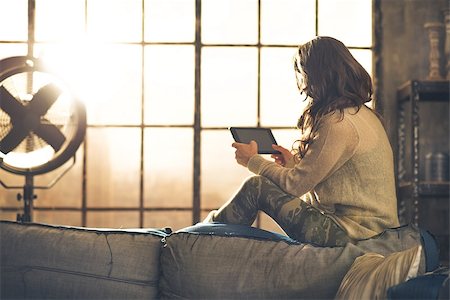person tablet home information - Young woman using tablet pc in loft apartment. rear view Stock Photo - Budget Royalty-Free & Subscription, Code: 400-07797247