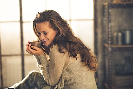 Portrait of relaxed young woman with cup of coffee in loft apartment Stock Photo - Budget Royalty-Free & Subscription, Code: 400-07797265